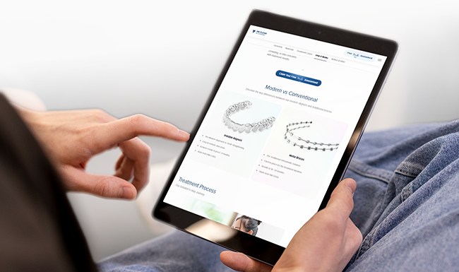 Tablet displaying clear aligner pricing and comparison chart on Dr Clear Aligners