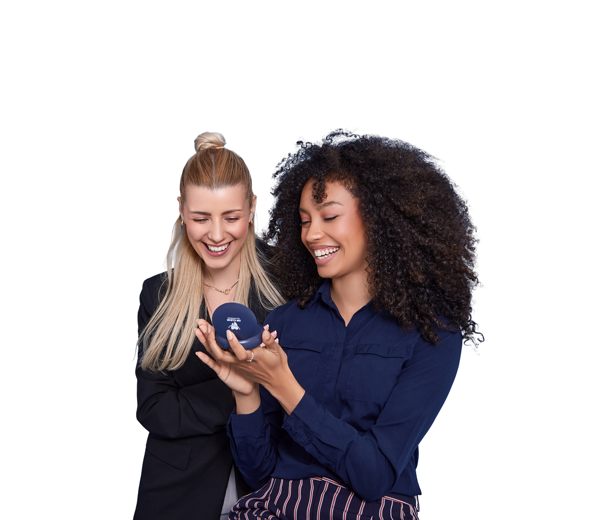 Two women smiling with clear aligners and Dr Clear Aligners case on bed