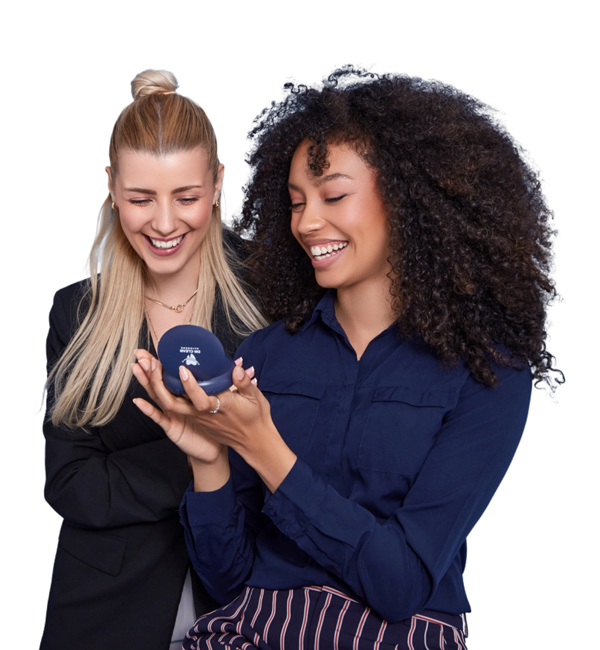 Two women smiling with clear aligners and Dr Clear Aligners case on bed
